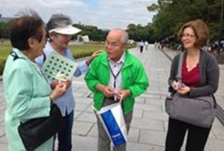 Akemi Yagi and Shouzou Kawamoto share their stories with visitors in the Hiroshima Memorial Peace Park. Both have dedicated their lives to promoting world peace and nuclear disarmament.