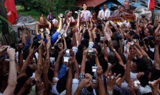 Burma's pro-democracy leader Aung San Suu Kyi addresses her supporters from her house compound after her release from house arrest. 